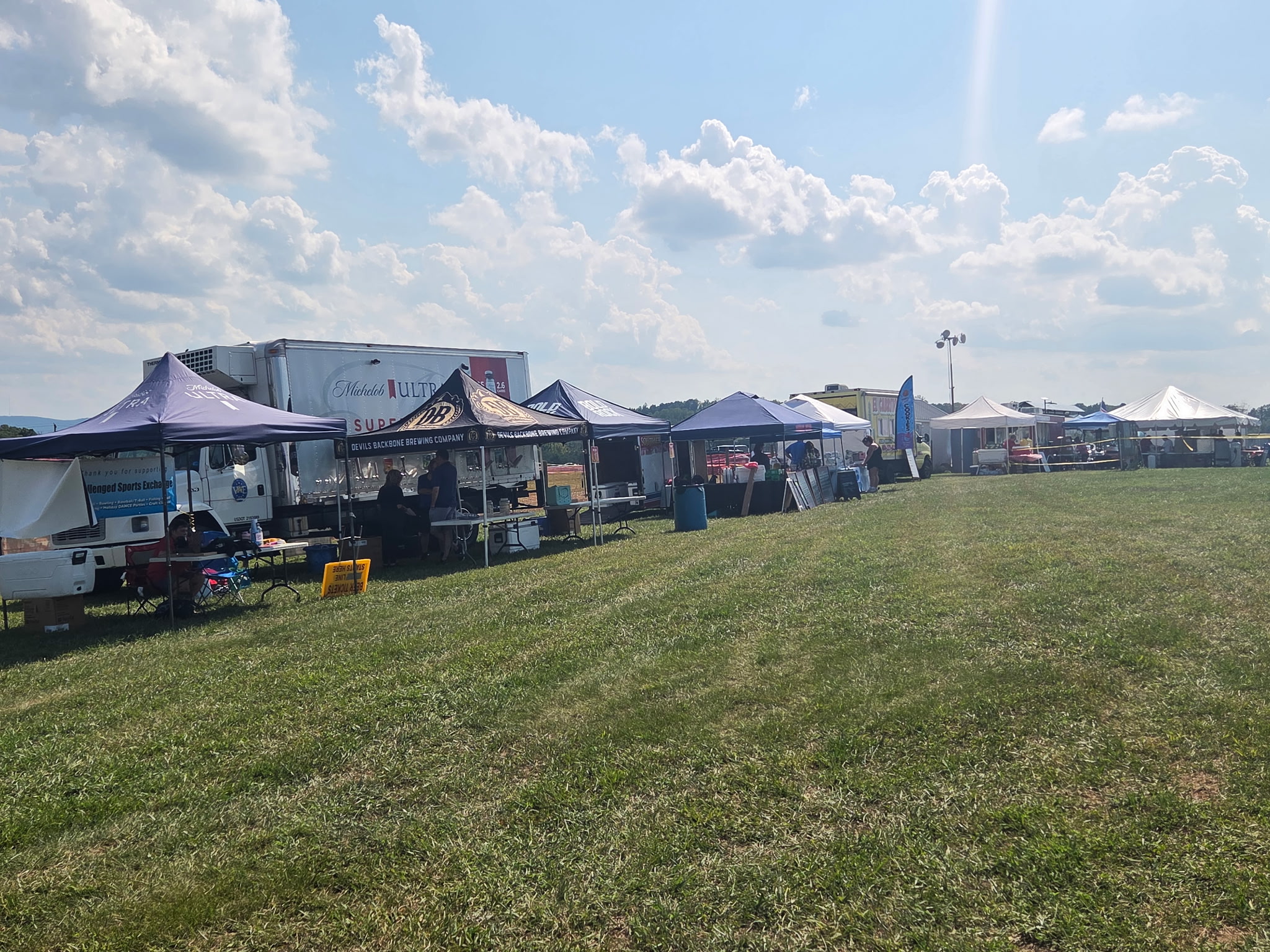 Long row of vendor tents at Sims Farm